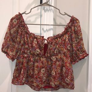 Evolutionary red floral cropped blouse. Keyhole neckline with short puff sleeves